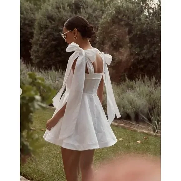 DISSH Aisle white linen bow mini dress - healthypet.id DISSH Aisle white linen bow mini dress - healthypet.id